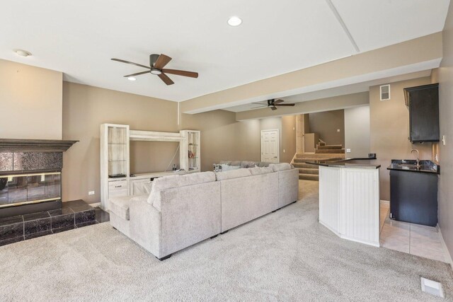 51 Oak Creek Dr, Burr Ridge, IL 60527 - carpeted living area featuring ceiling fan, stairs, a tile fireplace, recessed lighting, and a sink