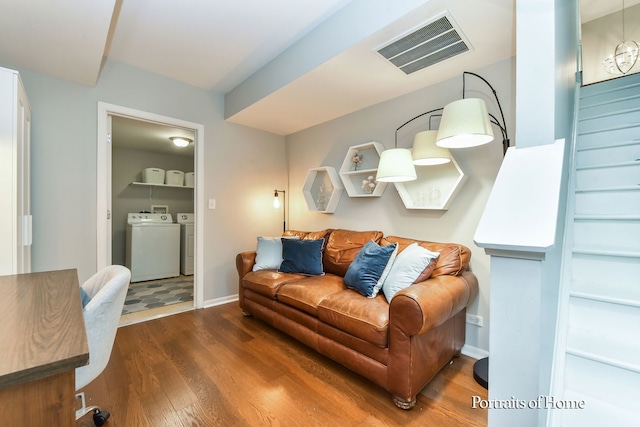 435 N Commerce St, Aurora, IL 60504 - living room with washing machine and dryer, wood finished floors, and baseboards