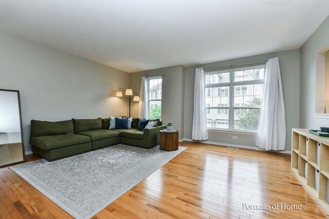 435 N Commerce St, Aurora, IL 60504 - living room with light wood-style floors and baseboards