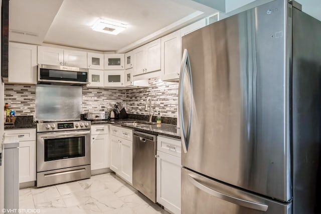 2237 175th St Unit 2A, Lansing, IL 60438 - kitchen with appliances with stainless steel finishes, a sink, light marble finish flooring, white cabinets, and dark stone countertops