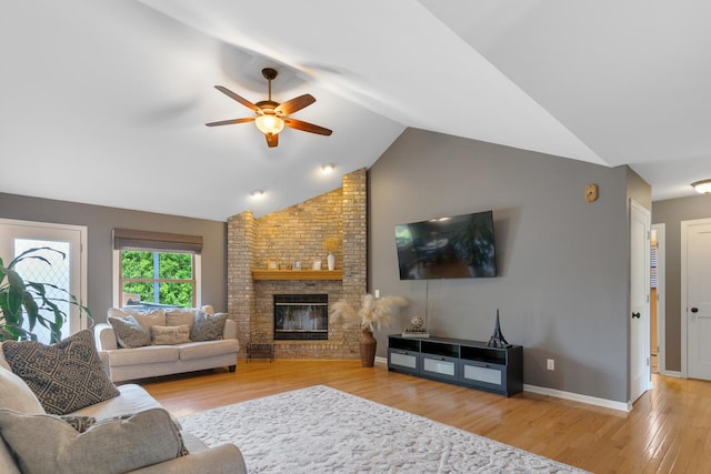 807 Meadow Ln, North Aurora, IL 60542 - living room featuring ceiling fan, wood finished floors, a brick fireplace, vaulted ceiling, and baseboards