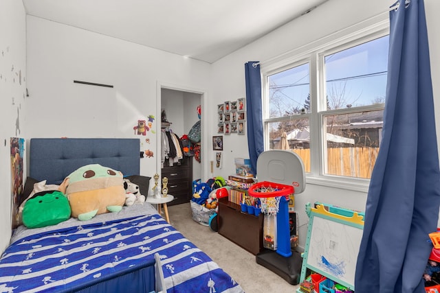 carpeted bedroom featuring a closet and a spacious closet