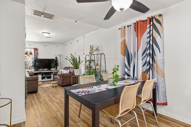 dining area with wood finished floors, ceiling fan, and baseboards