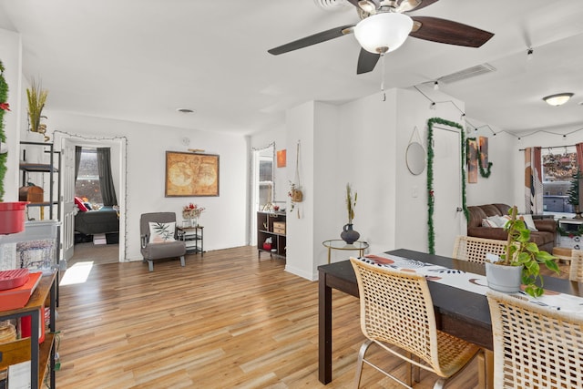 dining space with light wood-style floors and a ceiling fan