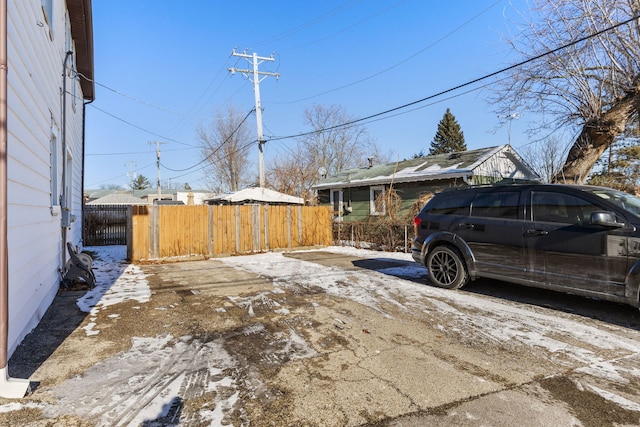 view of side of home featuring fence