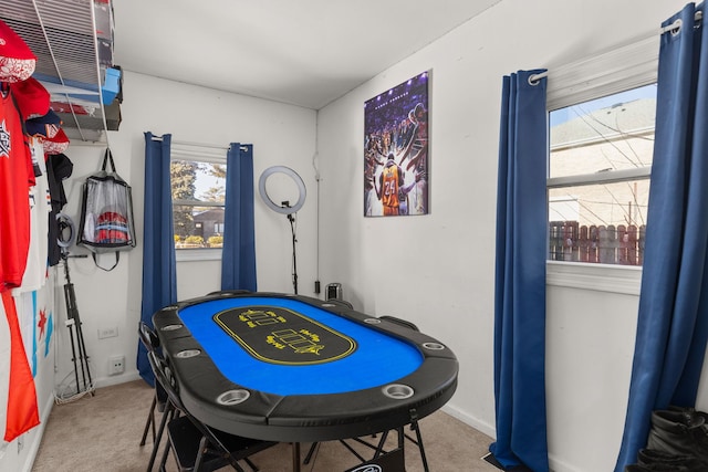 rec room featuring carpet floors and baseboards