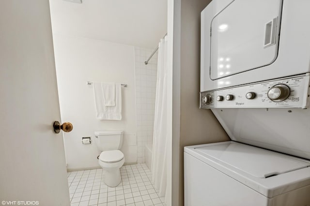 40 E Delaware Pl Unit 301, Chicago, IL 60611 - bathroom featuring stacked washing machine and dryer, tile patterned floors, toilet, and shower / tub combo with curtain