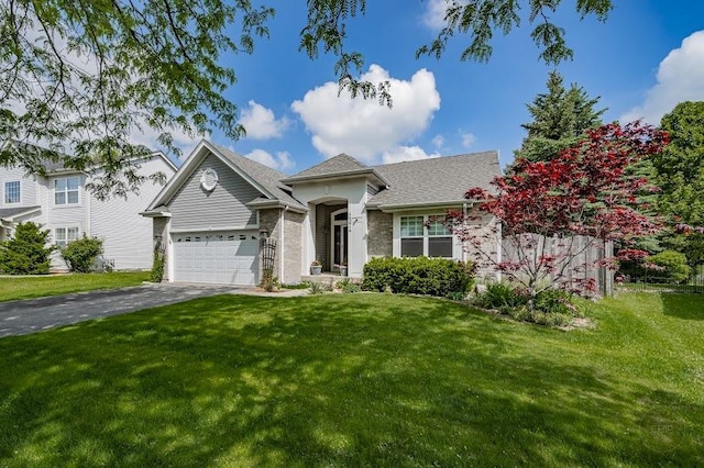 view of front of house featuring an attached garage, asphalt driveway, and a front lawn