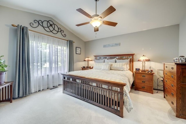 carpeted bedroom featuring vaulted ceiling and ceiling fan