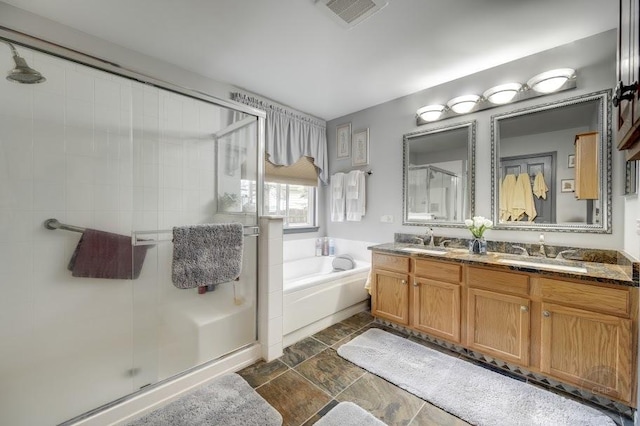 bathroom with a shower stall, a garden tub, and stone finish flooring