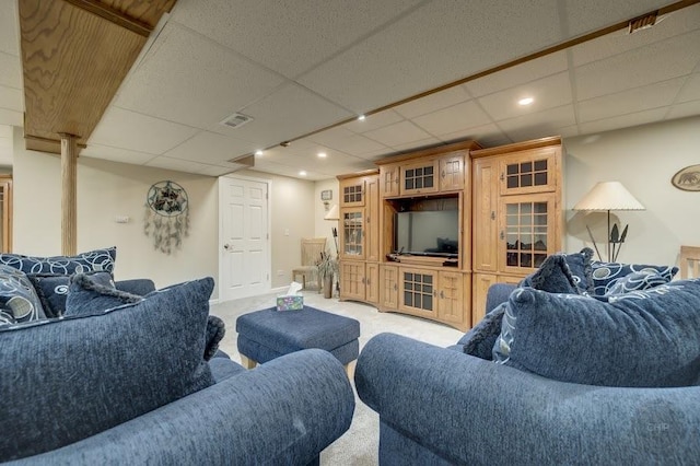 living area with light colored carpet, a paneled ceiling, and recessed lighting