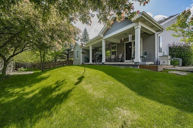 rear view of house featuring a porch
