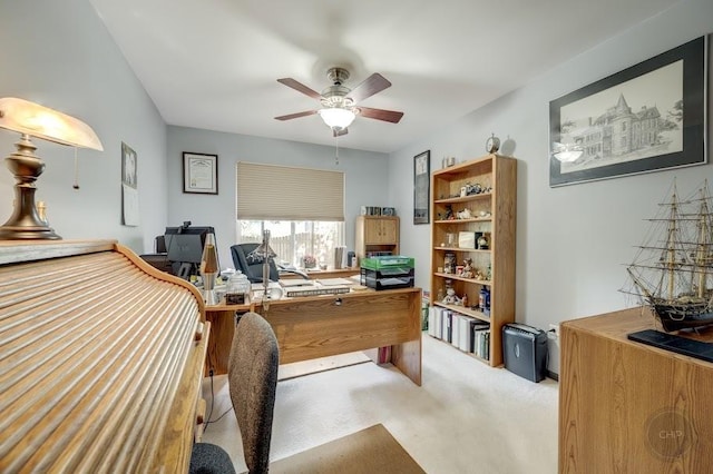 office with carpet and a ceiling fan