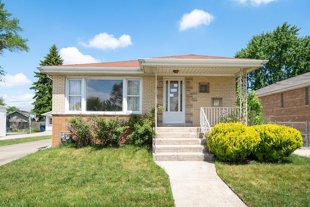 2820 W 100th Pl, Evergreen Park, IL 60805 - view of front of property featuring brick siding, a front yard, and a porch