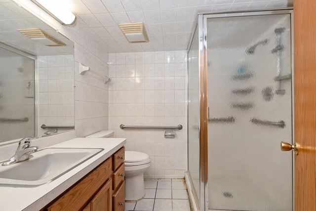 2820 W 100th Pl, Evergreen Park, IL 60805 - bathroom with a stall shower, vanity, tile patterned flooring, toilet, and tile walls