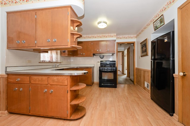 2820 W 100th Pl, Evergreen Park, IL 60805 - kitchen featuring black appliances, open shelves, light wood-type flooring, wainscoting, and brown cabinetry