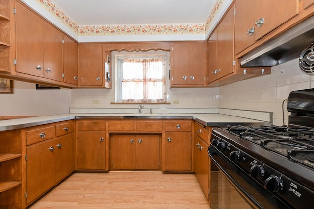 2820 W 100th Pl, Evergreen Park, IL 60805 - kitchen featuring black gas range, open shelves, under cabinet range hood, light wood finished floors, and brown cabinetry