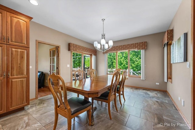 1122 Souders Ave, Elburn, IL 60119 - dining room with baseboards, a chandelier, and light stone finish floors