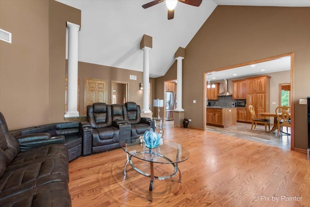 1122 Souders Ave, Elburn, IL 60119 - living area with decorative columns, high vaulted ceiling, a ceiling fan, and light wood-type flooring