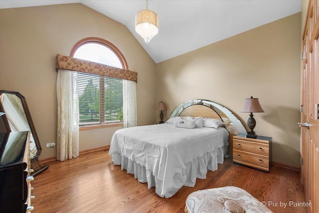 1122 Souders Ave, Elburn, IL 60119 - bedroom featuring lofted ceiling, wood finished floors, and baseboards