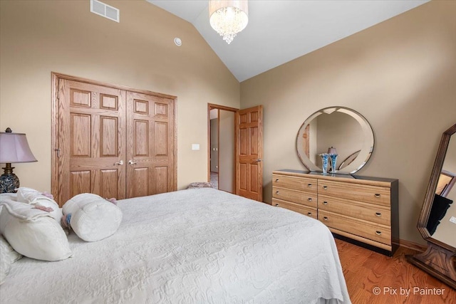 1122 Souders Ave, Elburn, IL 60119 - bedroom featuring wood finished floors, a chandelier, and high vaulted ceiling