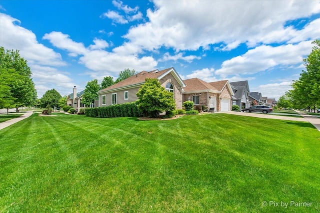1122 Souders Ave, Elburn, IL 60119 - view of side of home featuring concrete driveway, a garage, a lawn, and brick siding