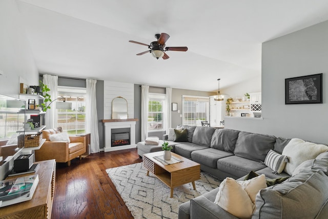4783 W Iris Ln, Monee, IL 60449 - living room featuring lofted ceiling, a ceiling fan, dark wood-style flooring, and a glass covered fireplace