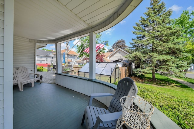 wooden deck with a residential view and a yard