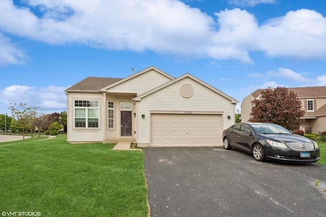view of front facade featuring a garage, driveway, and a front lawn