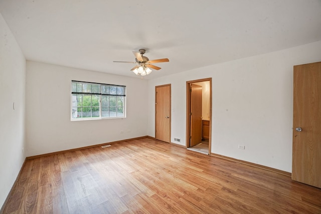 14603 Maple Ln, Dolton, IL 60419 - unfurnished bedroom with light wood-type flooring, baseboards, ceiling fan, and ensuite bath