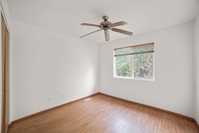 14603 Maple Ln, Dolton, IL 60419 - empty room with light wood finished floors, baseboards, and a ceiling fan