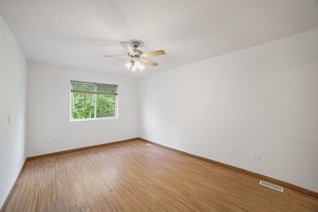 14603 Maple Ln, Dolton, IL 60419 - empty room featuring wood finished floors, ceiling fan, and baseboards