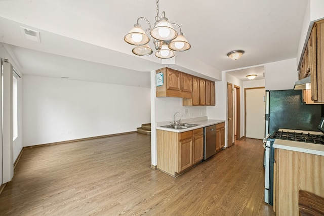 14603 Maple Ln, Dolton, IL 60419 - kitchen featuring stainless steel appliances, a sink, light countertops, wood finished floors, and a chandelier