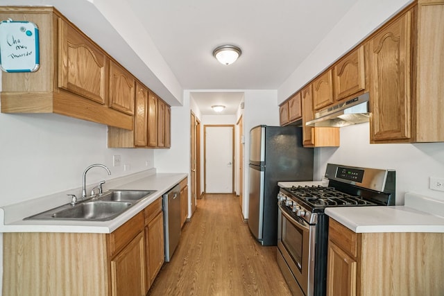 14603 Maple Ln, Dolton, IL 60419 - kitchen with appliances with stainless steel finishes, under cabinet range hood, a sink, light wood-type flooring, and light countertops