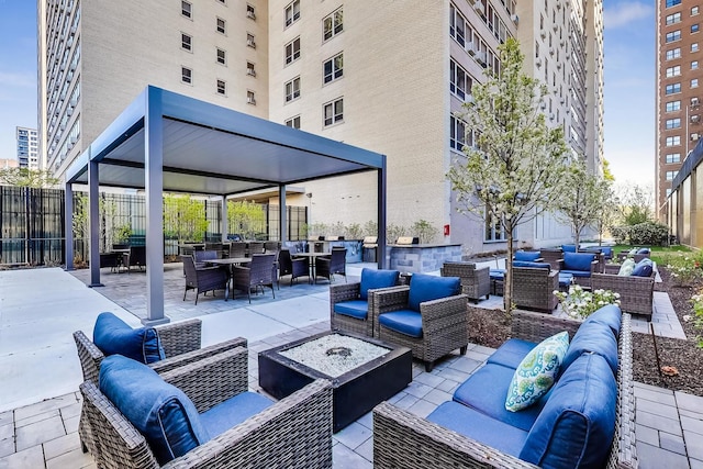 view of patio featuring an outdoor living space with a fire pit, fence, a gazebo, and outdoor dining area