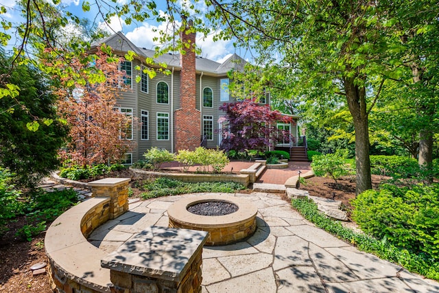 view of patio / terrace featuring an outdoor fire pit and a wooden deck