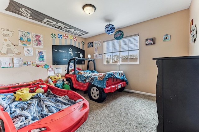 carpeted bedroom featuring baseboards