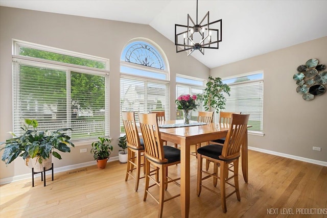 1514 Somerfield Dr, Bolingbrook, IL 60440 - dining space with vaulted ceiling, light wood-type flooring, a chandelier, and baseboards