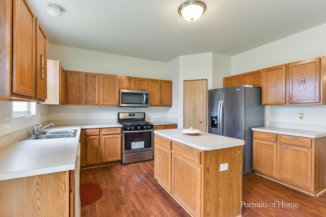 8408 Coop Ave, Joliet, IL 60431 - kitchen with appliances with stainless steel finishes, dark wood finished floors, a center island, and light countertops