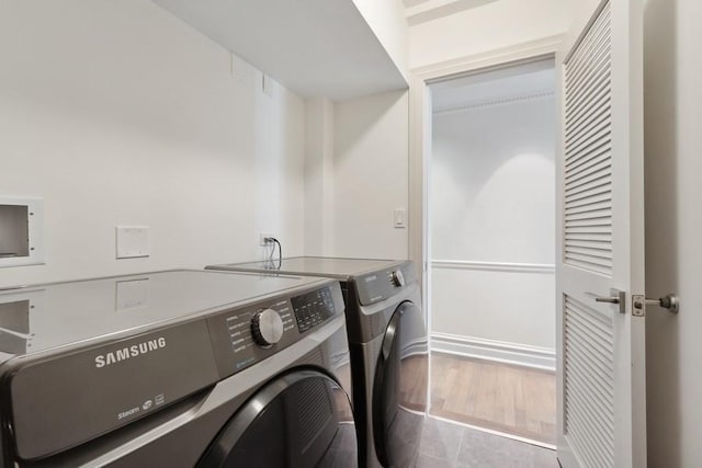 clothes washing area featuring independent washer and dryer