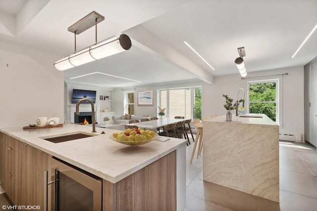 kitchen featuring a sink, wine cooler, a baseboard radiator, and modern cabinets