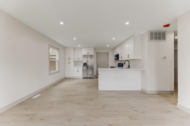 519 Everette Ave, Romeoville, IL 60446 - kitchen featuring stainless steel fridge, black microwave, white cabinetry, a sink, and light wood-style flooring