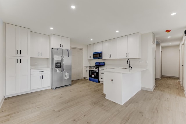 519 Everette Ave, Romeoville, IL 60446 - kitchen featuring stainless steel appliances, a sink, a peninsula, light wood finished floors, and recessed lighting
