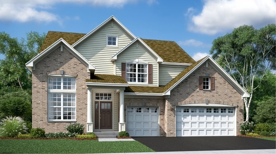 traditional-style house with asphalt driveway and brick siding