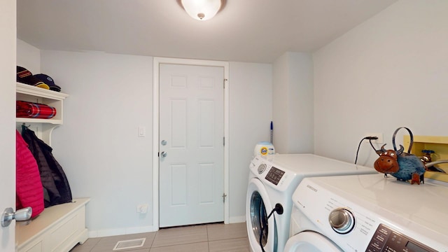 2030 N Oak Wood Dr, Arlington Heights, IL 60004 - clothes washing area with washing machine and clothes dryer, light tile patterned floors, and baseboards