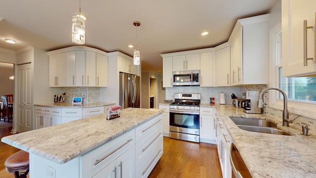 2030 N Oak Wood Dr, Arlington Heights, IL 60004 - kitchen featuring appliances with stainless steel finishes, a sink, a kitchen island, recessed lighting, and white cabinets