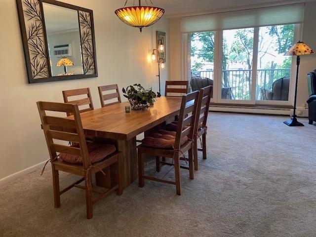 2211 S Highland Ave Unit 4B, Lombard, IL 60148 - carpeted dining space featuring baseboards and a textured ceiling