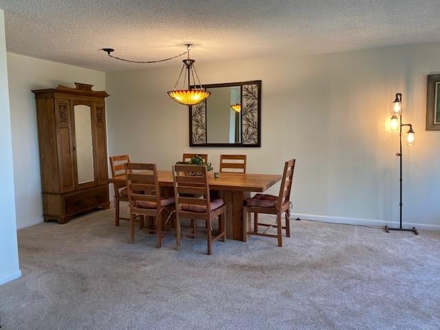 2211 S Highland Ave Unit 4B, Lombard, IL 60148 - kitchen featuring black appliances, light wood-style floors, light countertops, a textured ceiling, and white cabinetry