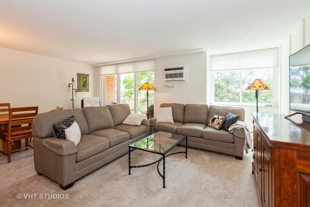 2211 S Highland Ave Unit 4B, Lombard, IL 60148 - living room featuring light carpet, a decorative wall, a wall mounted AC, and a textured ceiling