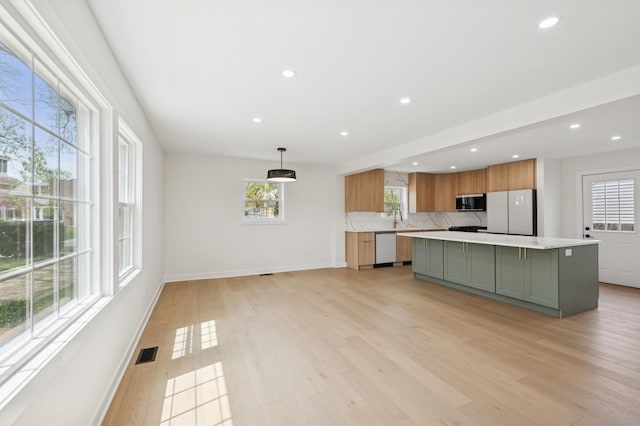 1929 S Ashland Ave, Park Ridge, IL 60068 - kitchen with freestanding refrigerator, light countertops, a center island, dishwashing machine, and light wood-type flooring